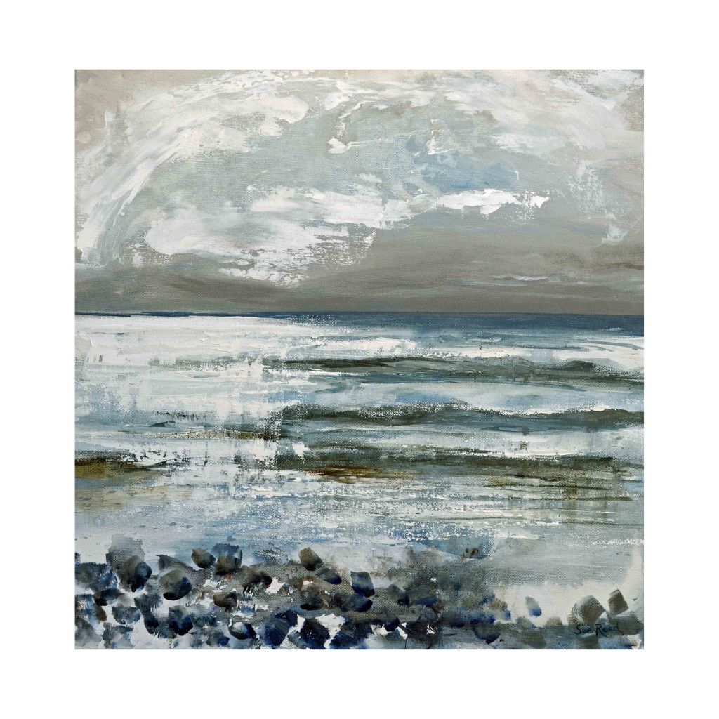 Winter scene in greys and blues with stones and surf coming in 